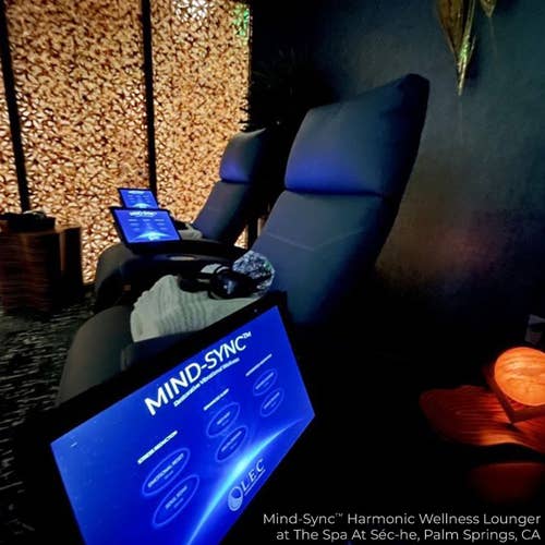 Two Living Earth Crafts Mind-Sync 2.0™ loungers offer stress relief in a tranquil, dim spa room.
