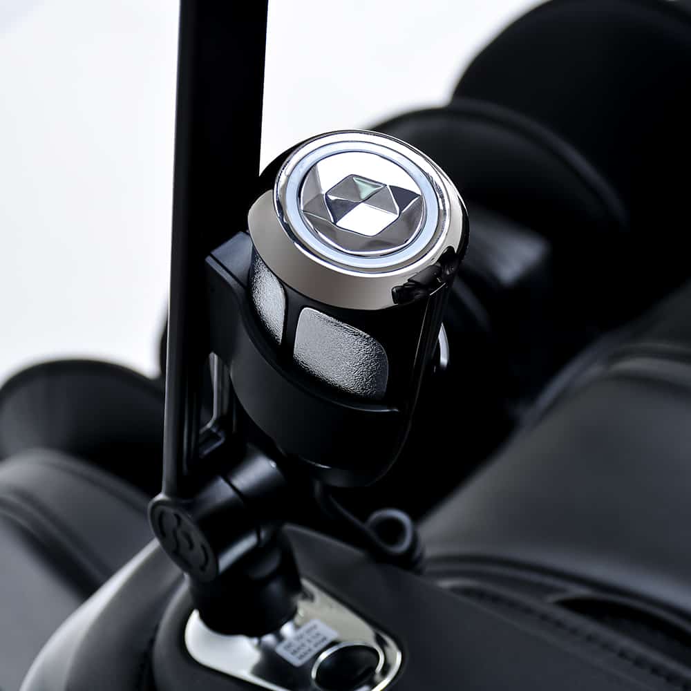 Close-up of a car gear shift knob with a silver and black finish, like the Ogawa Master Drive AI 2.0.