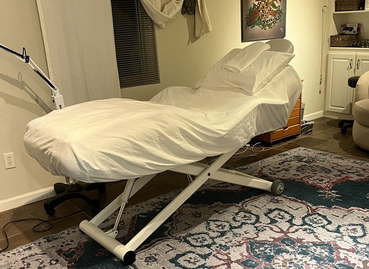 Silverfox America 2274B Electric Massage Bed, ADA compliant, in a cozy, softly lit room.