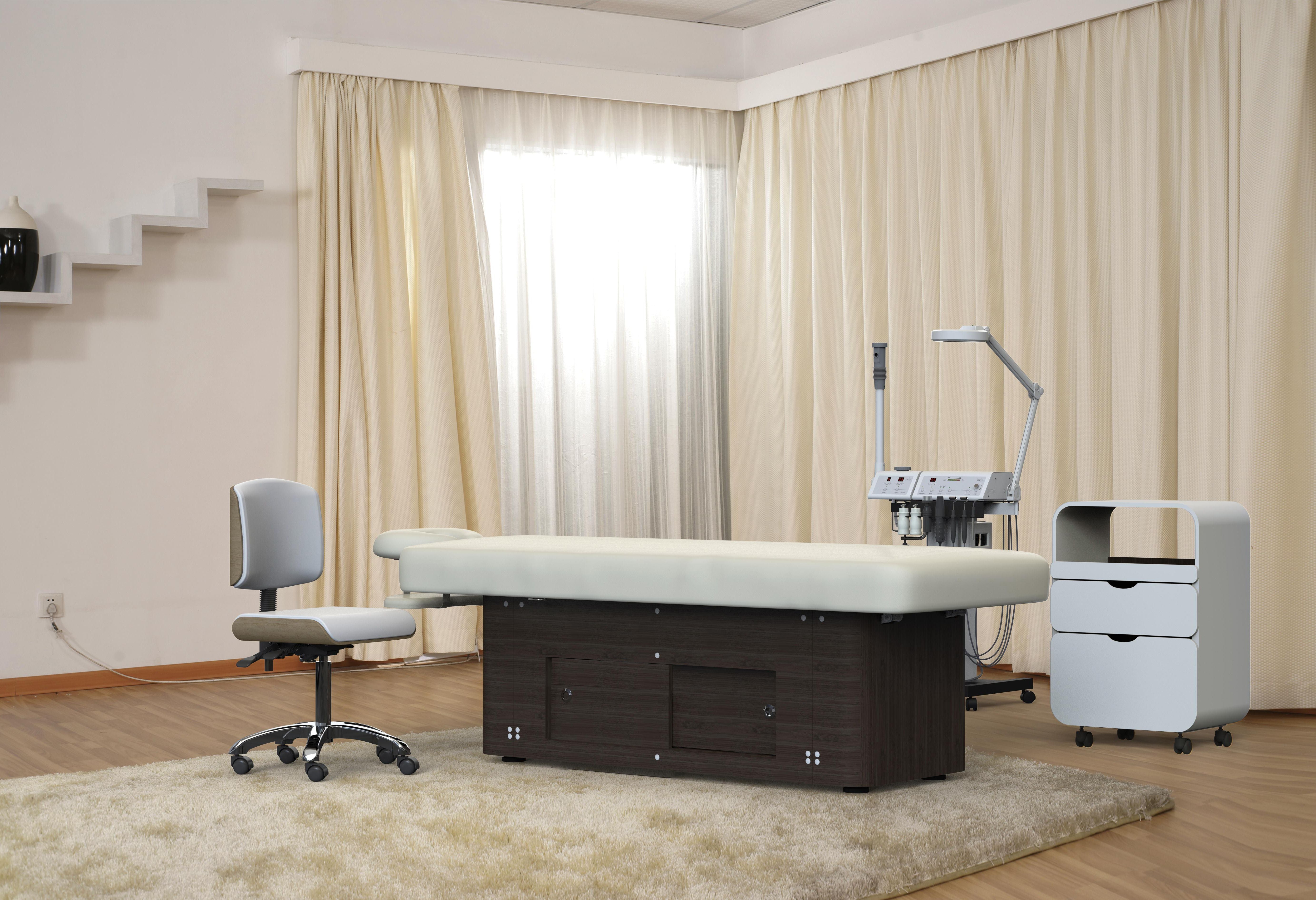 Medical exam room with exam table, rolling chair, and Silverfox America 2285B massage table.
