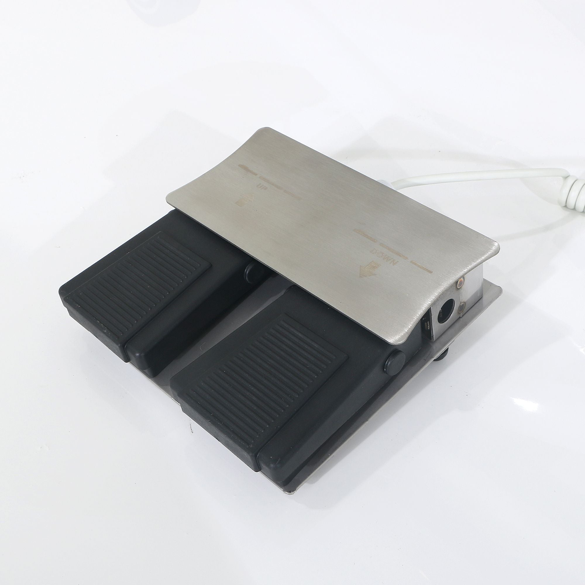 Dual black foot pedals with metal cover for Silverfox America 2274 electric massage table.