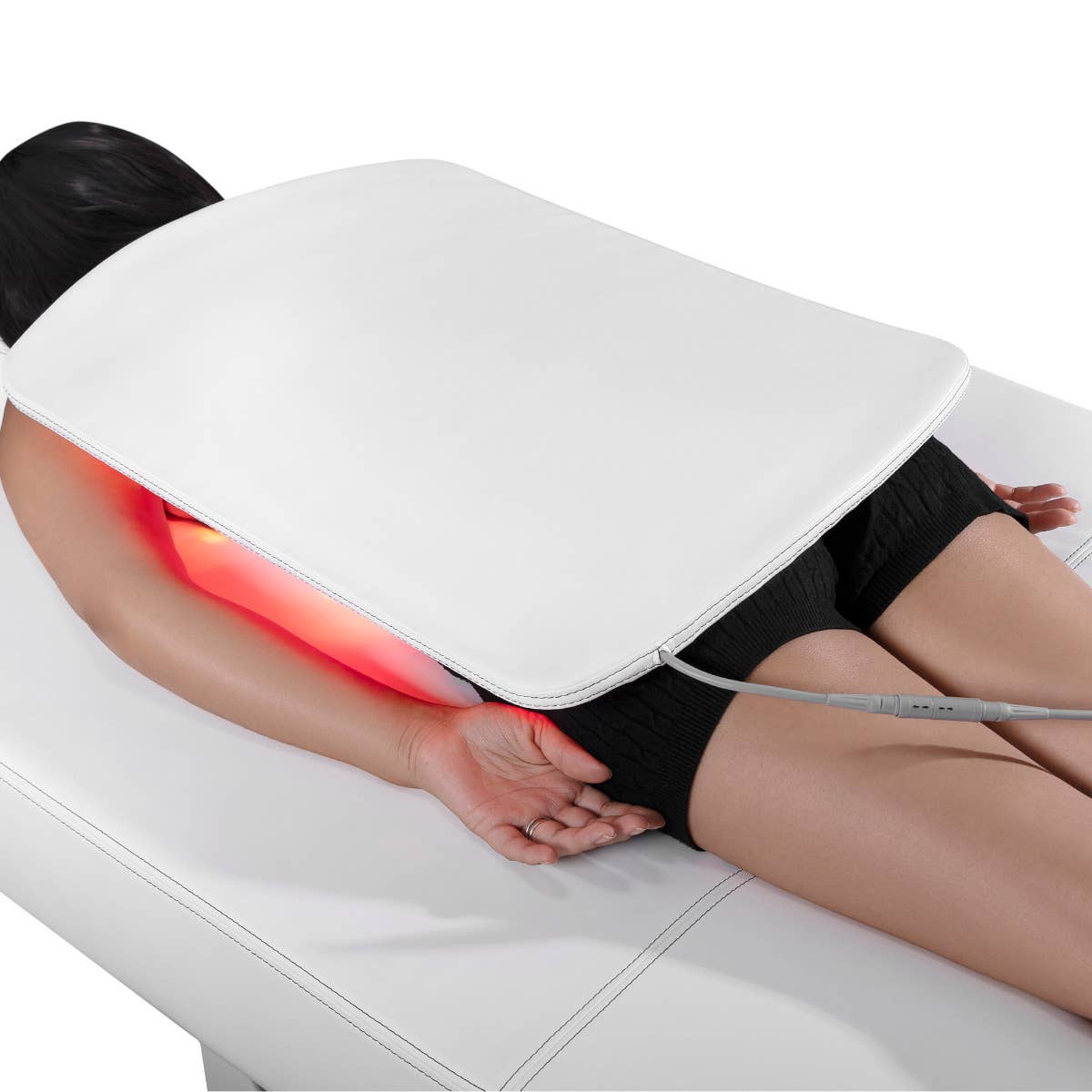 Person lying on the Living Earth Crafts RADIANCE PT LED Light Therapy Treatment Table.