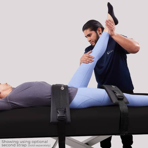 An EarthLite ELLORA Table with Stretch Assist helps stretch a person's leg during treatment.