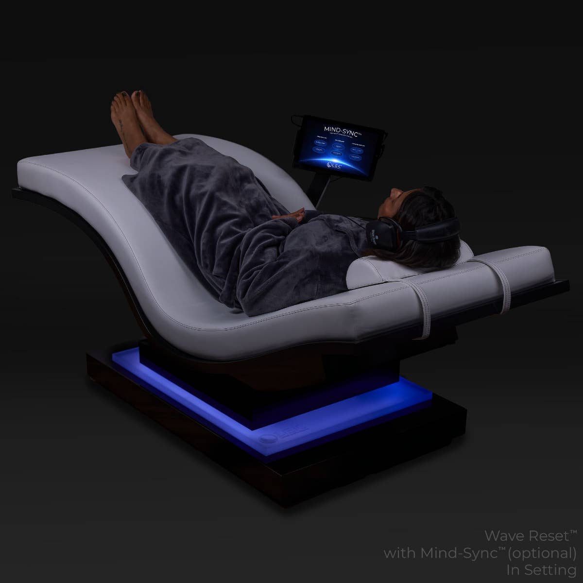 Person reclines on Living Earth Crafts WAVE RESET Lounger, IceBlock™ blue chromatherapy base.
