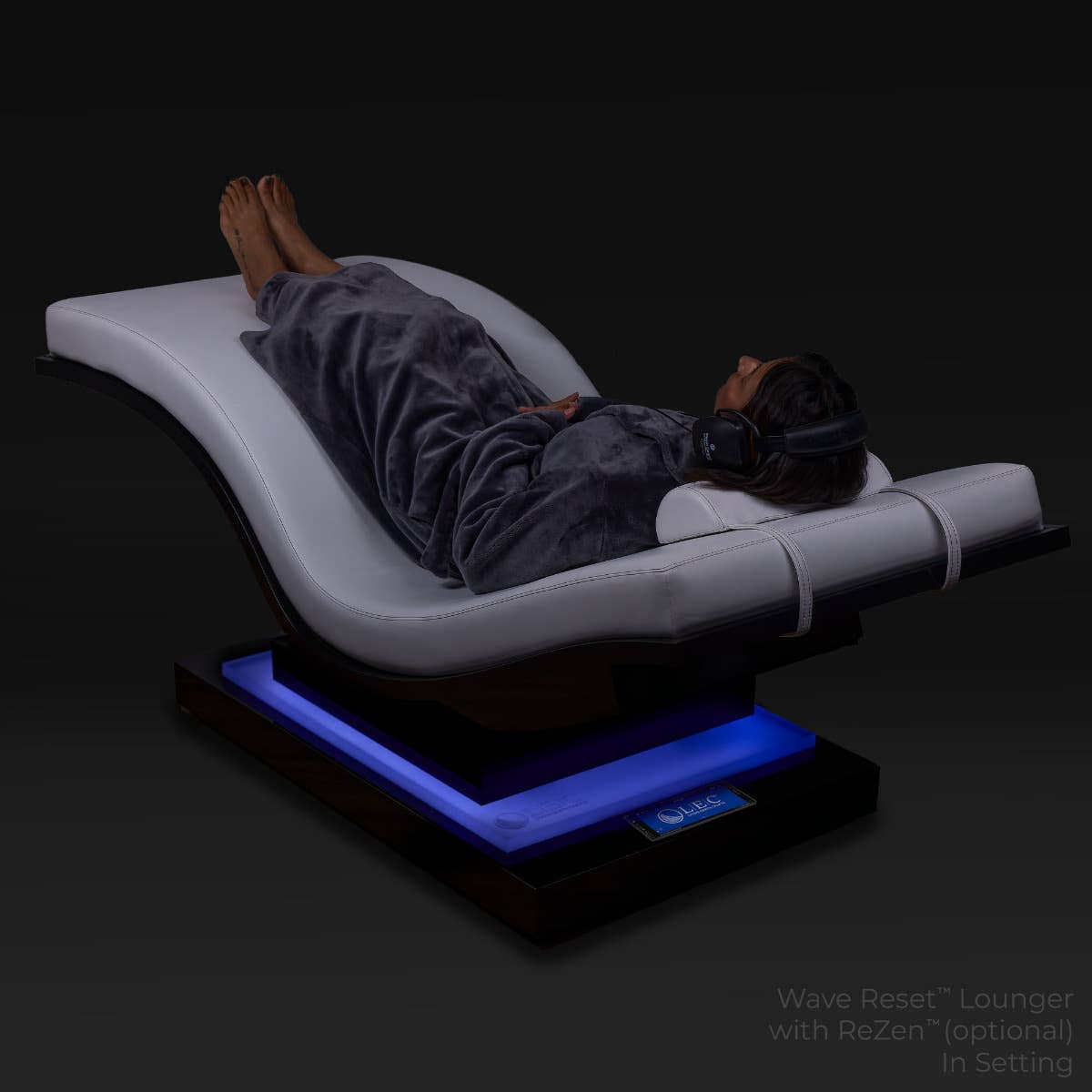 Person relaxing on a Living Earth Crafts WAVE RESET Lounger with IceBlock™ Chromatherapy base.