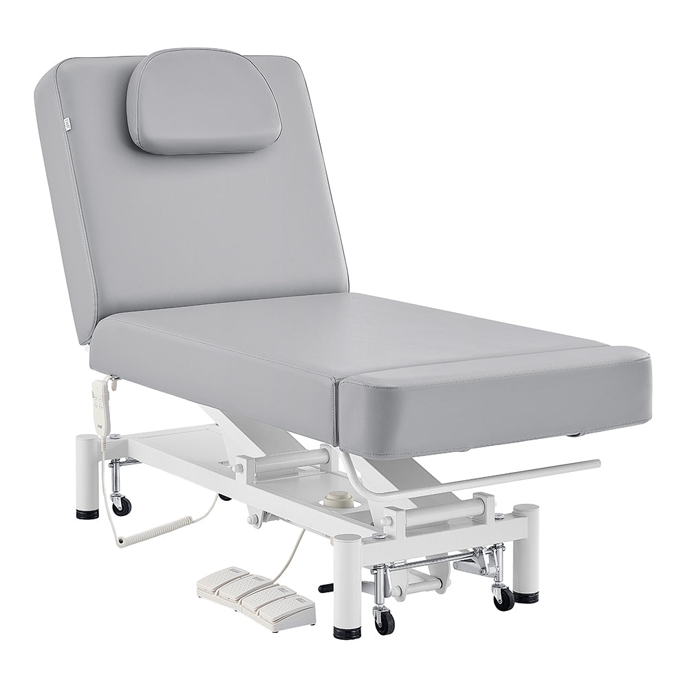 The DIR WellRelax Treatment Table is gray, adjustable, with cushioned headrest and foot pedals.