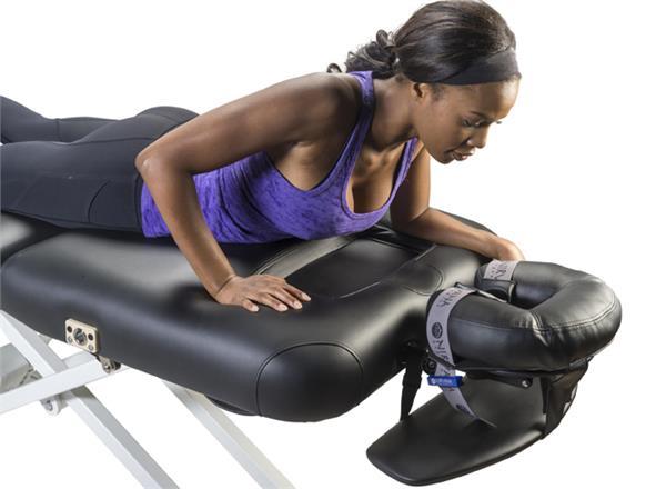 Woman lying face down on Nirvana Salon Top Electric Massage Table with padded face cradle.