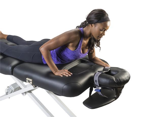 Woman on Nirvana Salon Top Electric Massage Table, lying face down with head in headrest.