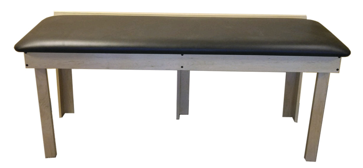 A wall-mount folding table with a black cushioned seat by PHS Chiropractic.