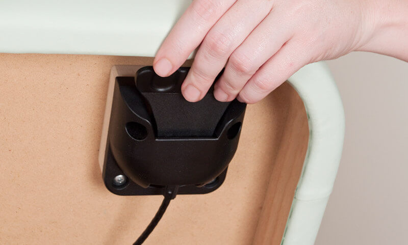 Hand adjusting control on Oakworks CLINICIAN Adjustable Lift-assist Salon Top upholstery.