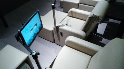 Three TouchAmerica DESTINY Pedicure Chairs in beige with monitor stands in a dimly lit room.