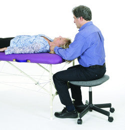 Person gets neck treatment on Pisces Pro NEW WAVE II Lite Portable Massage Table.
