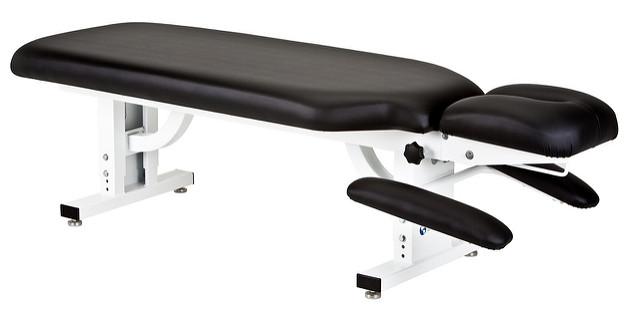 EarthLite APEX STATIONARY Massage Table with adjustable headrest and padded arm supports.