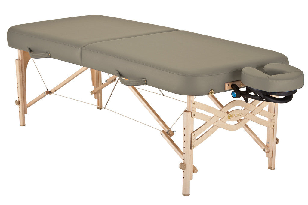 EarthLite SPIRIT portable massage table with cushioned top, wood legs, and face cradle.