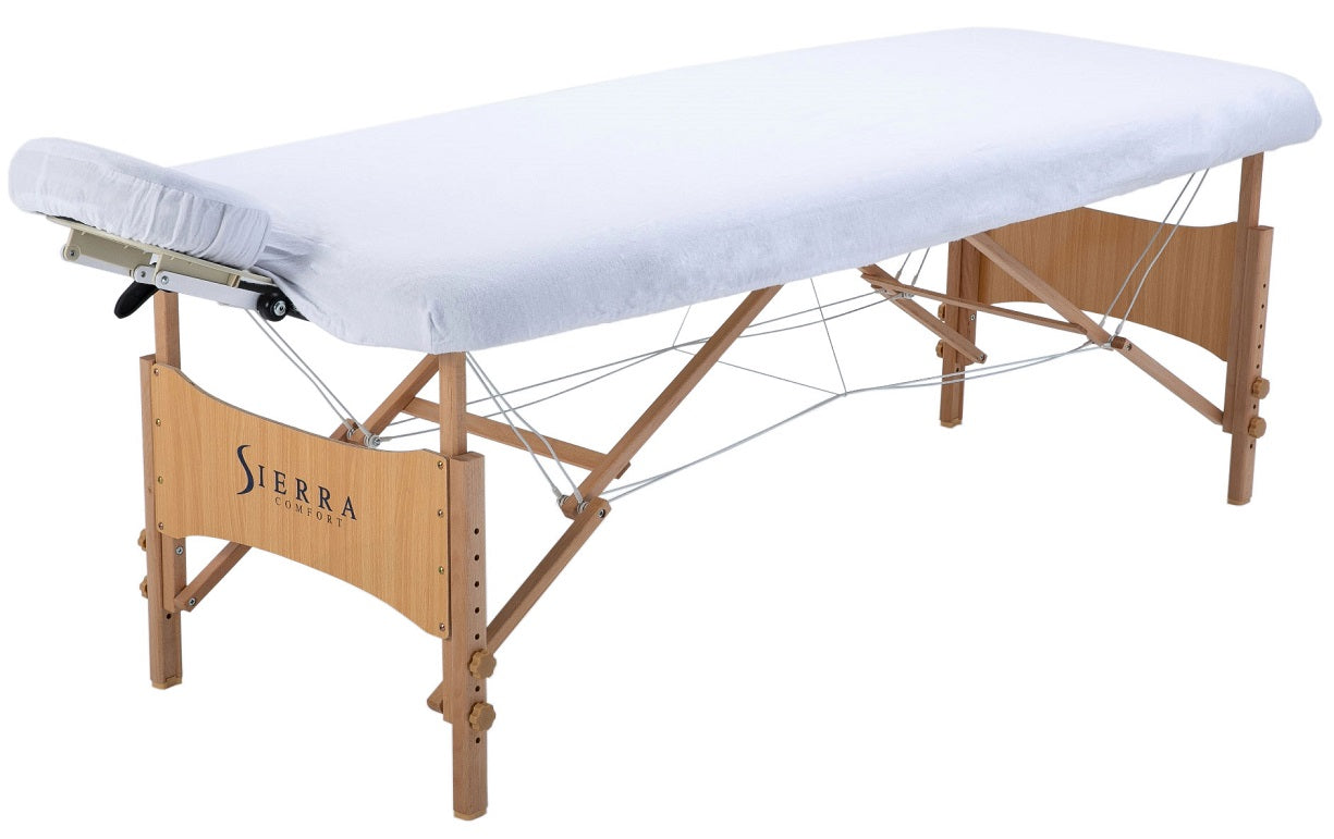 Sierra Comfort ALL-INCLUSIVE portable massage table with white padding and headrest.