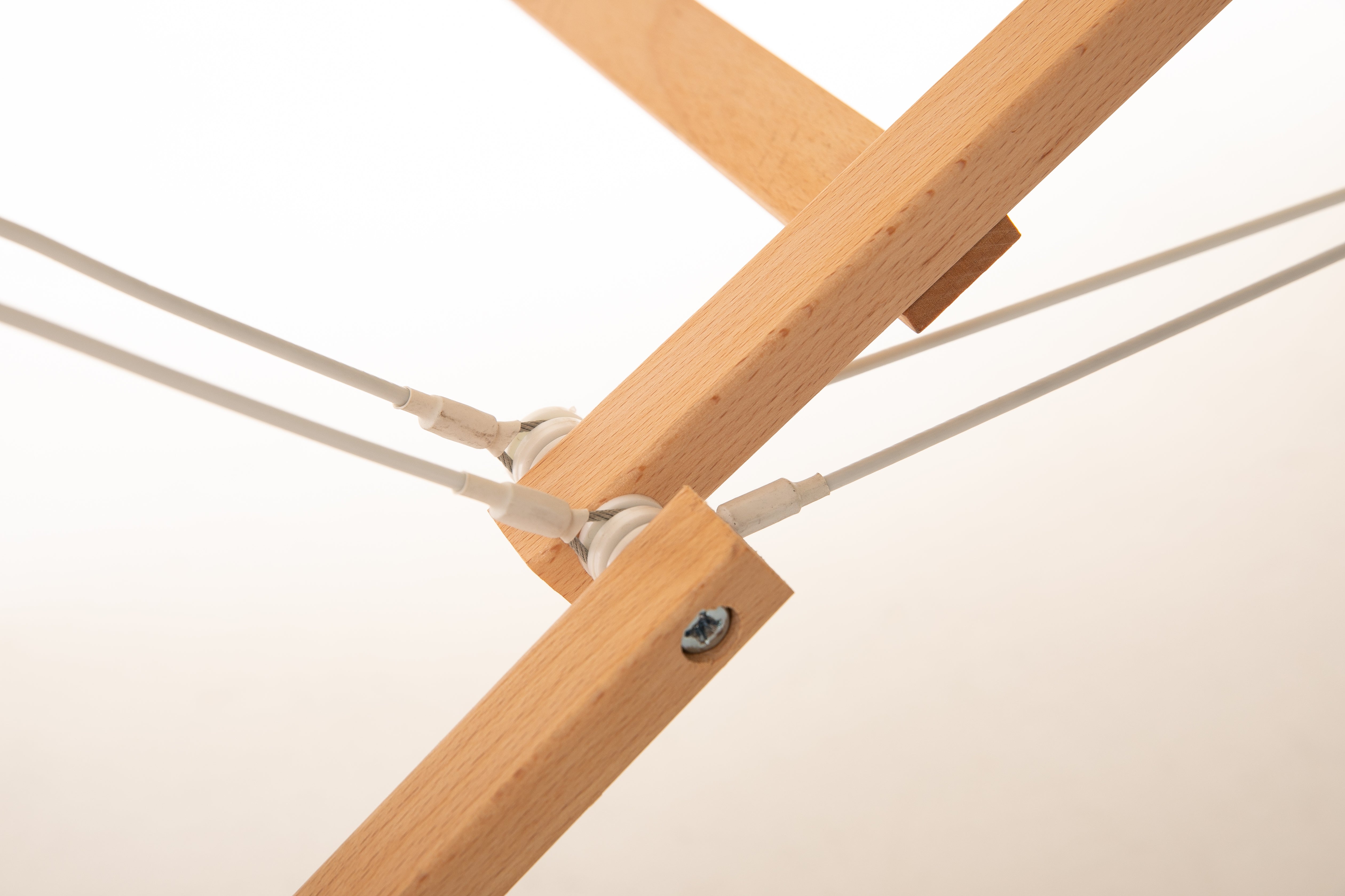 Close-up of Sierra Comfort ALL-INCLUSIVE Massage Table rods joined by screw, cords through pulleys.