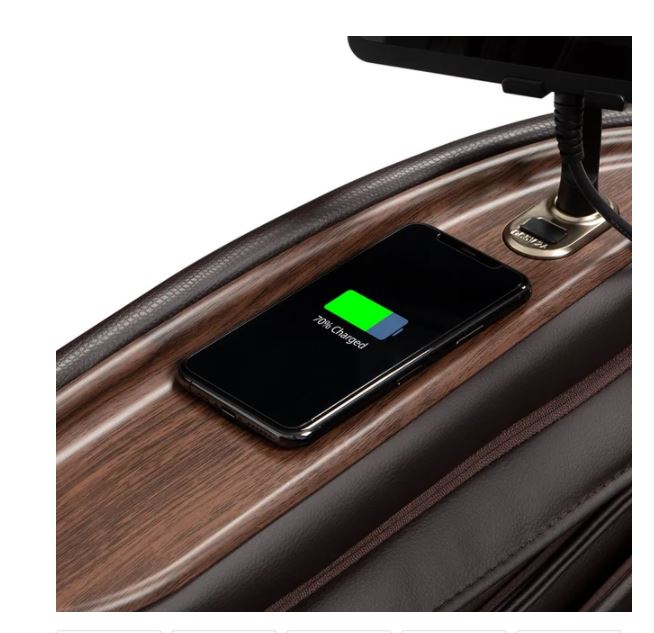 A smartphone charges on a tray next to the Osaki Amamedic Hilux 4D Electric Massage Chair.