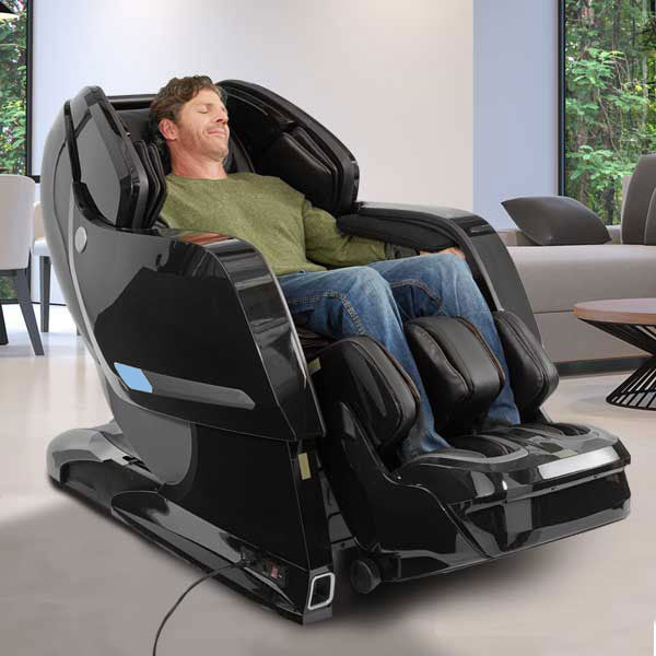 Man relaxing in a Kyota YOSEI M868 4D Electric Massage Chair in a modern living room.