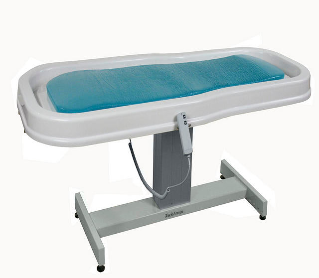 TouchAmerica Neptune Battery Wet Table with blue cushion, perfect for hydrotherapy treatments.