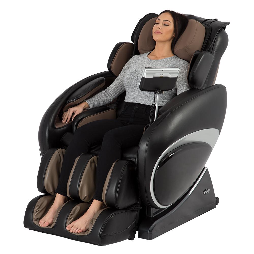 Woman relaxing in an Osaki OS-4000 Massage Chair with eyes closed and hands on the armrests.