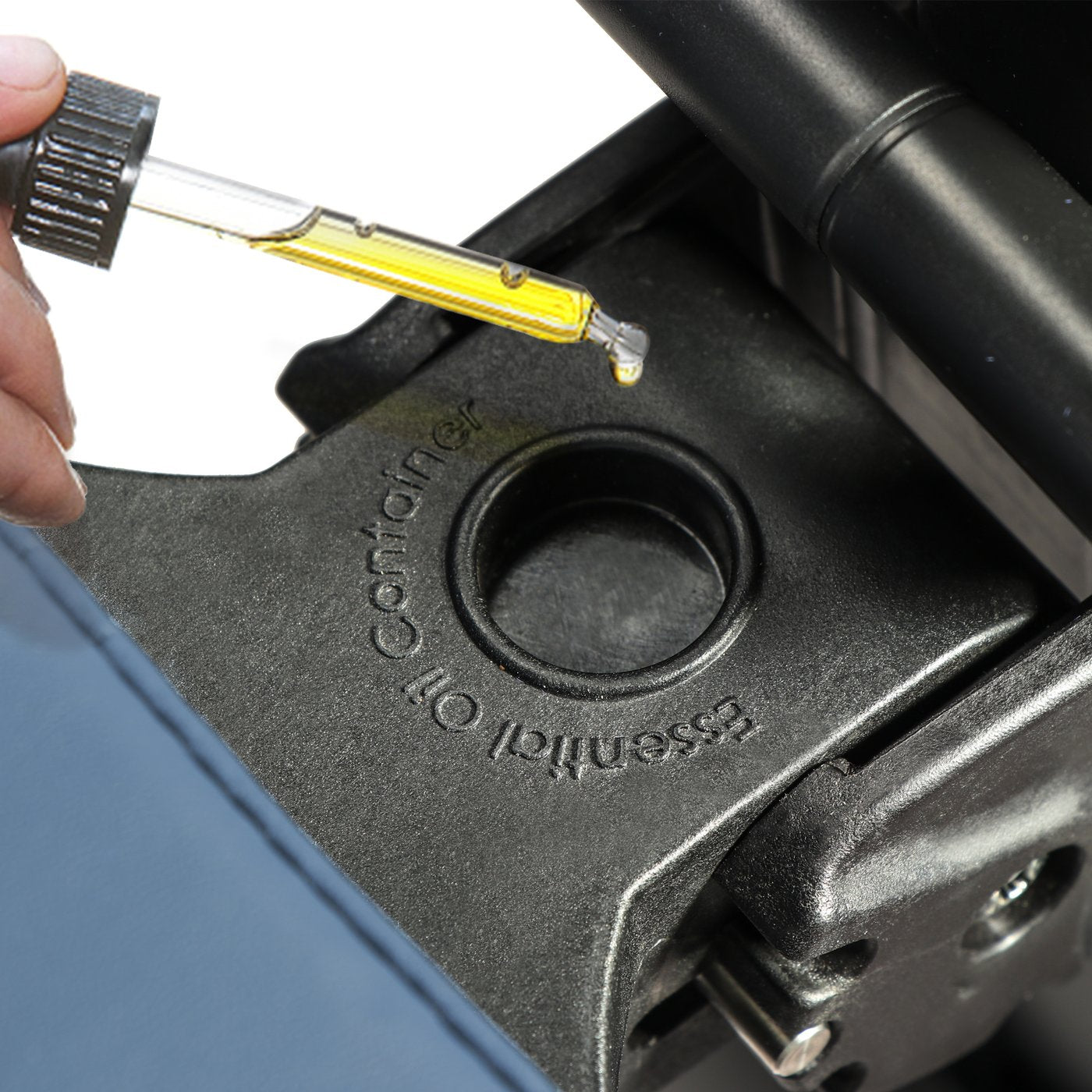 A dropper with yellow liquid is held over a Master Massage Gymlane Portable Massage Chair.