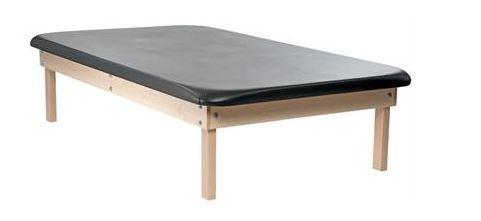 The PHS Chiropractic CLASSIC Wood Mat Table - 4 Leg features a black foam top for therapy use.