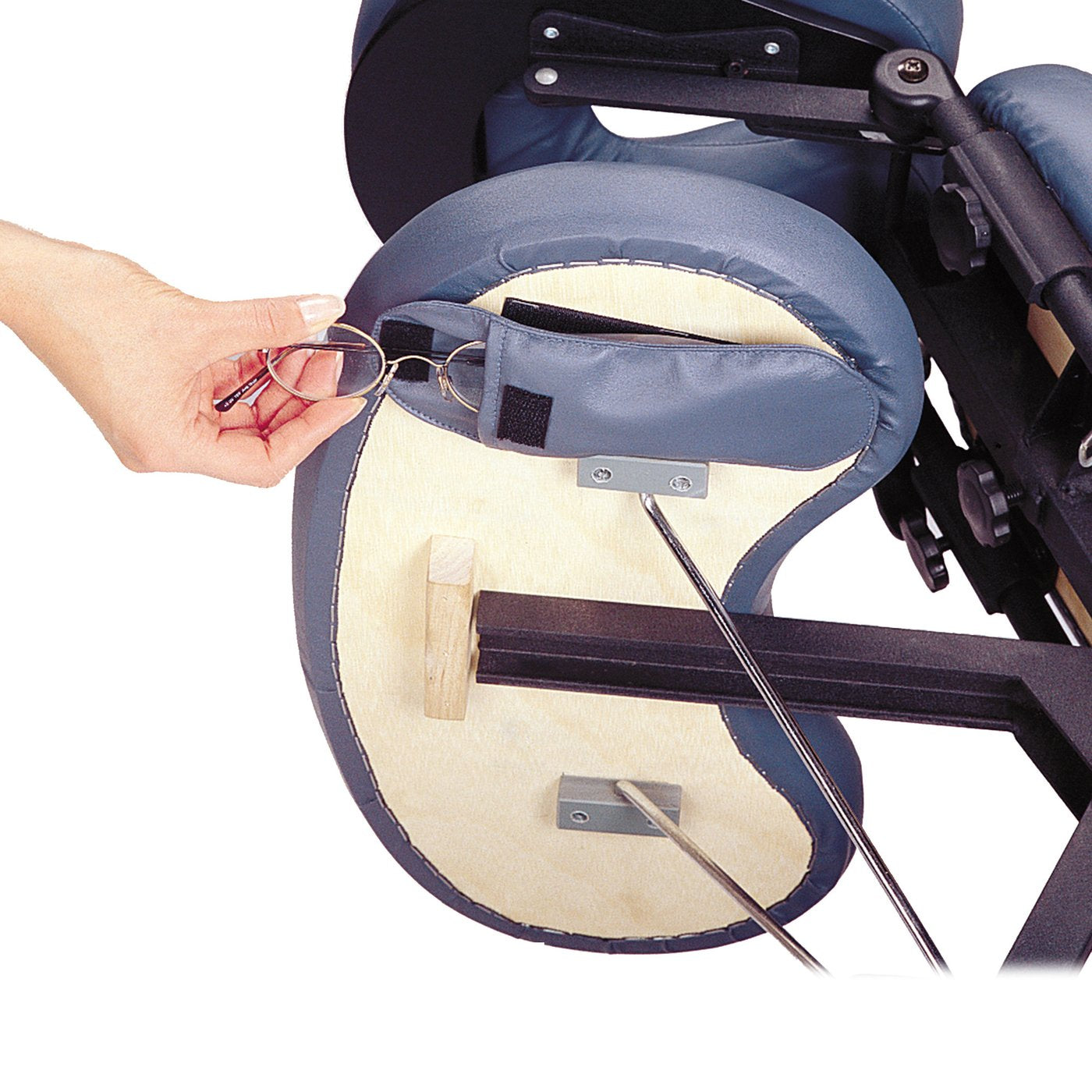 A hand puts eyeglasses in a strap on the Master Massage PROFESSIONAL Portable Massage Chair.