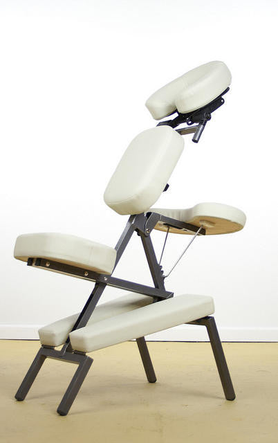 A white TouchAmerica QUICKLITE Massage Chair with a metal frame sits on a beige floor.