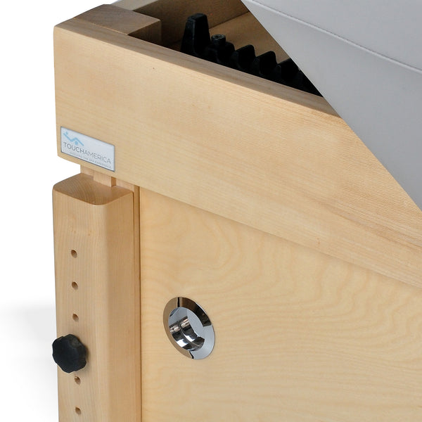 Close-up of TouchAmerica SONDI Treatment Table corner with adjustable knob and metal hardware.
