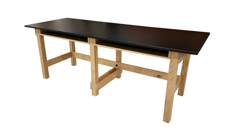 PHS Chiropractic CLASSROOM/LAB Table by PHS Chiropractic with black top and light wooden legs.