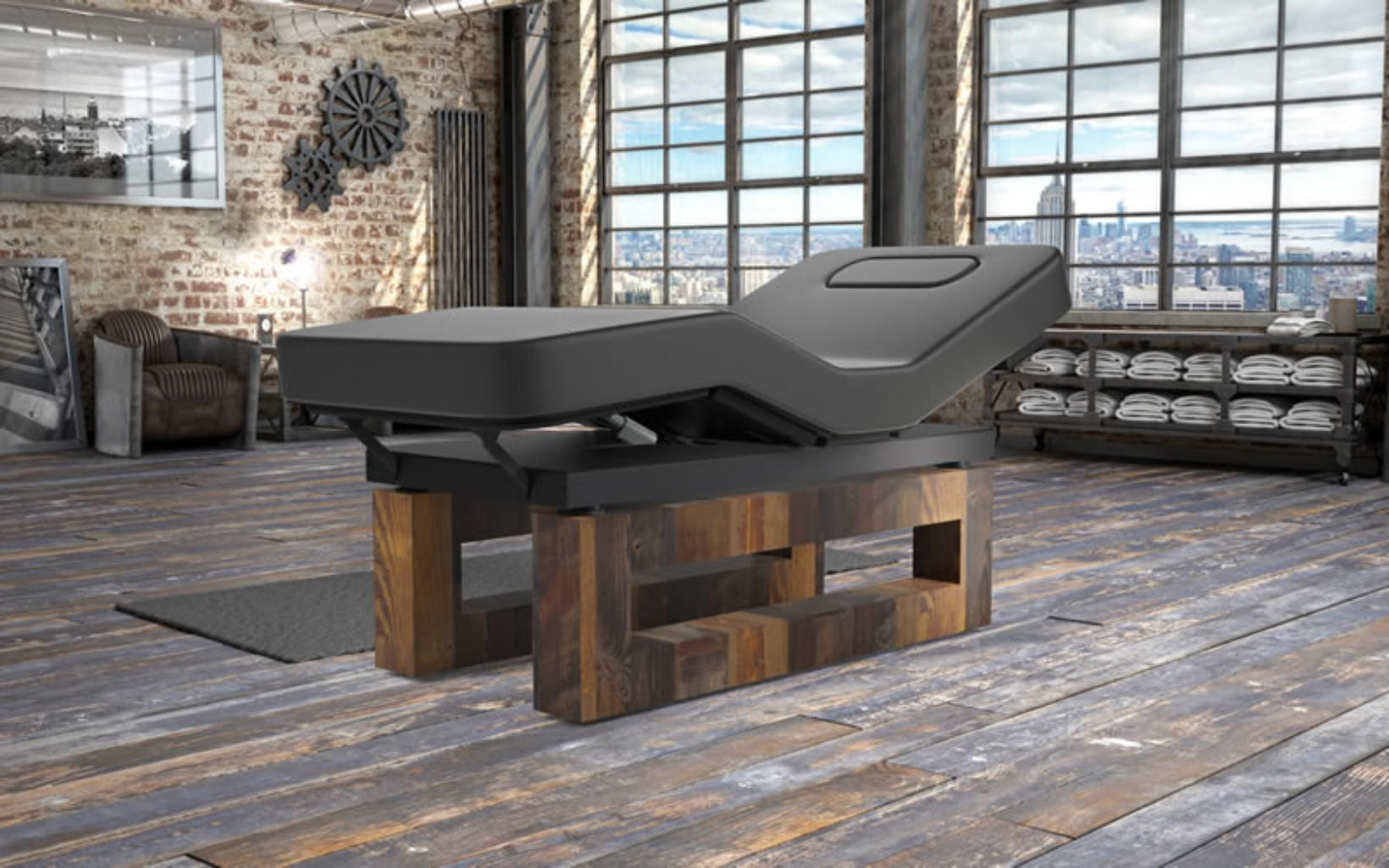 Oakworks Spa ICON Master's Collection black table on wooden base in a loft-style room.