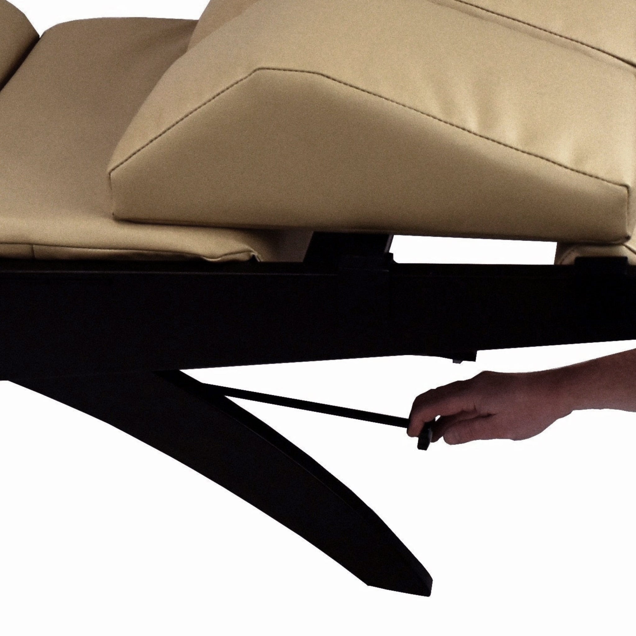 A hand adjusts the lever under a TouchAmerica Breath Pedi-Lounge with RX Sound and Split Knee Cushion.