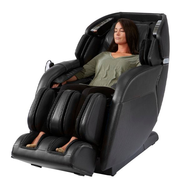 Woman relaxing in a Kyota M673 Kenko massage chair, eyes closed, enjoying a full body massage.