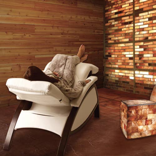 Relaxing on a Living Earth Crafts ZG Dream™ Lounger in a Himalayan salt brick room.