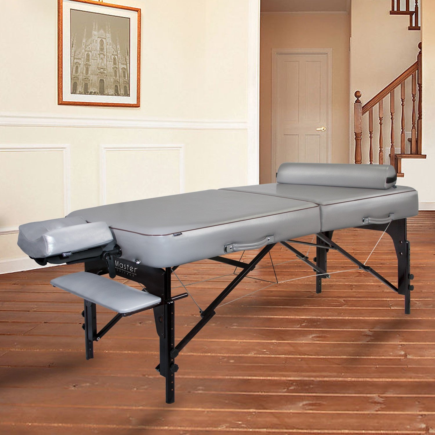 A Master Massage MONTOUR table package in gray is set up on wooden floors.
