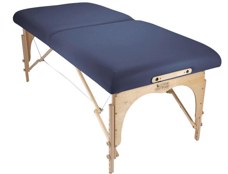 Custom Craftworks OMNI Sports Massage Table: blue cushion, wooden legs—great for deep tissue massage.