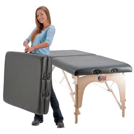Woman folding a Custom Craftworks OMNI Sports Massage Table with black padding, ideal for sports massage.