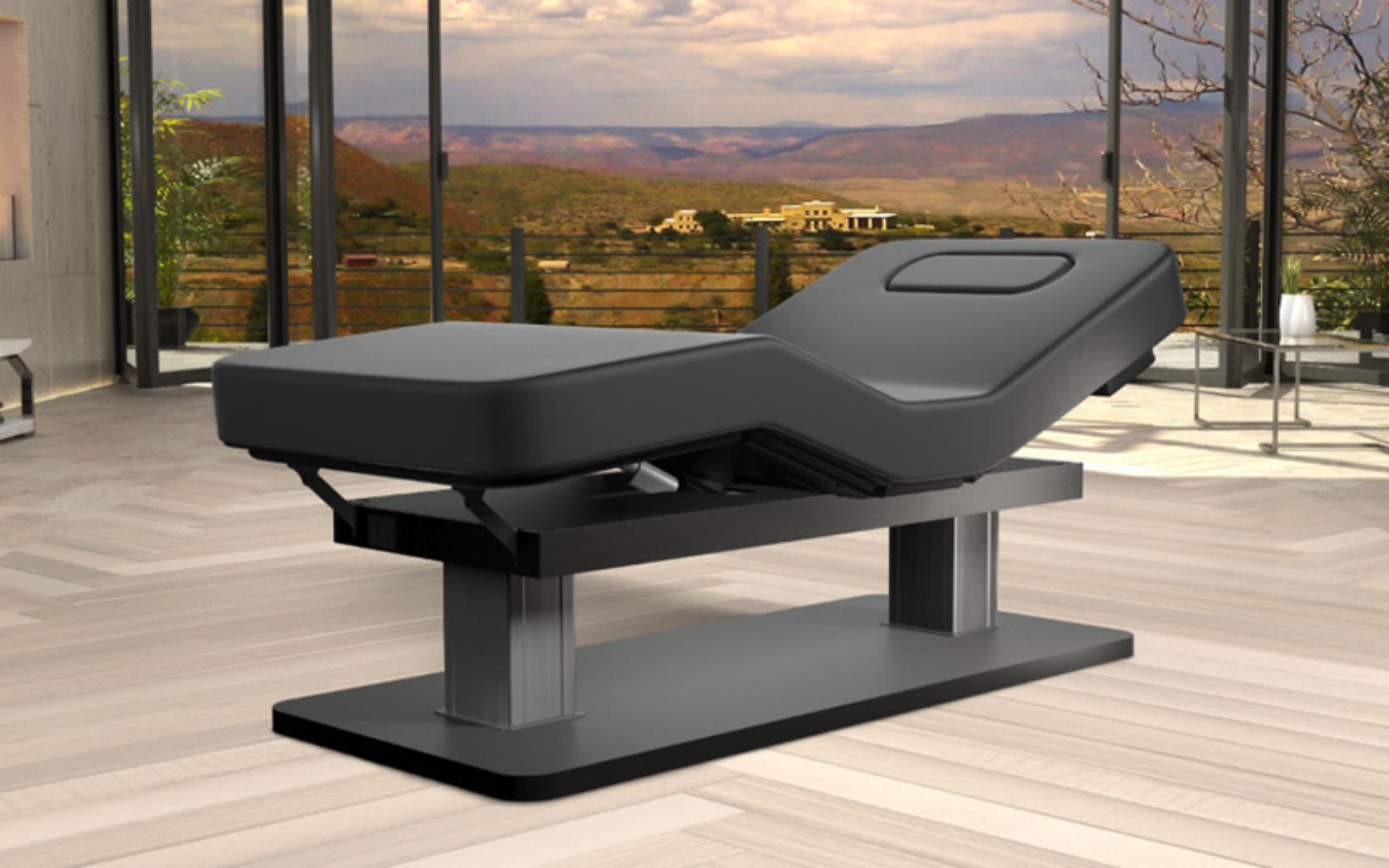 Oakworks Spa PALAS Table in a modern room with large windows and scenic outdoor view.