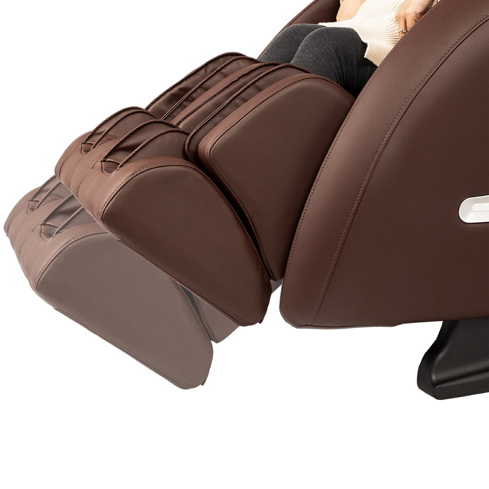 Person relaxing in an Osaki OS-4000XT massage chair with adjustable foot and leg support.