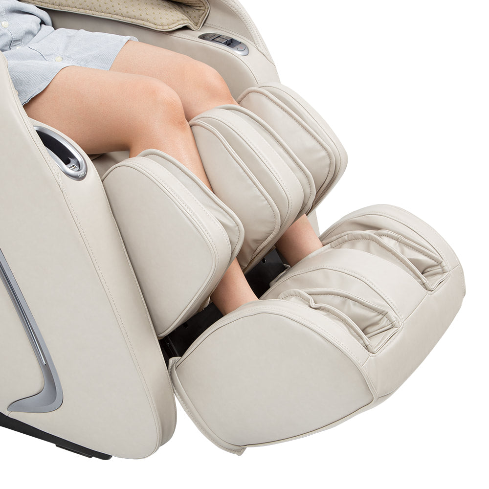 Person relaxing in a Titan TP-Cosmo Massage Chair with calf and foot massagers in use.