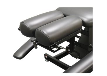 PHS Chiropractic ERGOBASIC table features adjustable padded leg supports and pelvic drop.